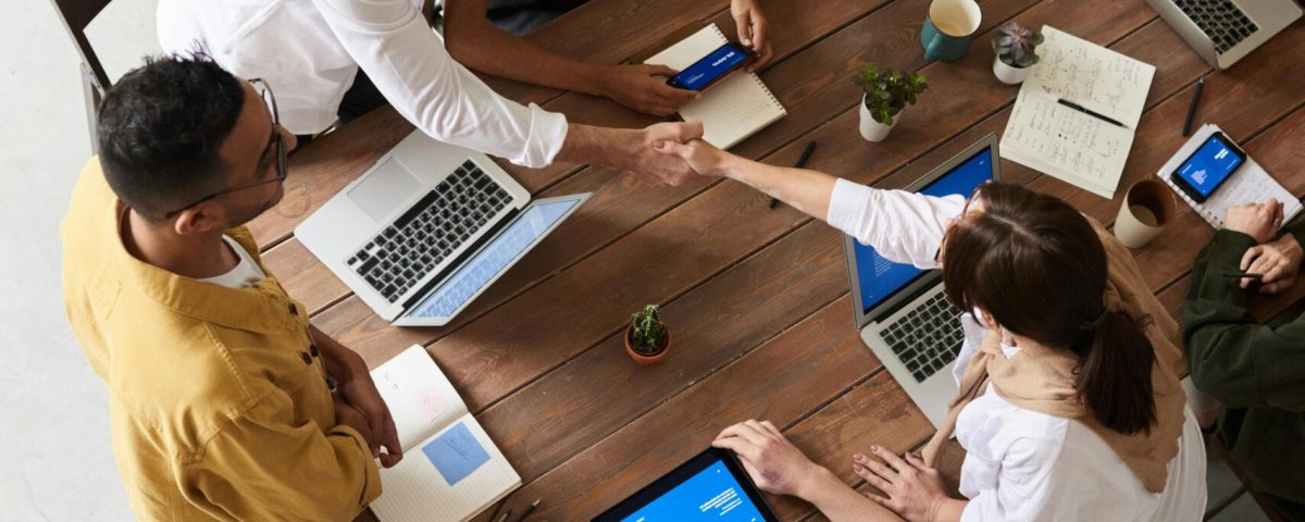 Overhead shot of a diverse team collaborating in a modern office meeting.